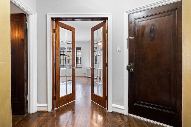 foyer entrance featuring dark hardwood / wood-style flooring and french doors