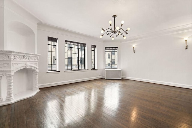 unfurnished living room with dark hardwood / wood-style flooring, radiator heating unit, ornamental molding, and a chandelier