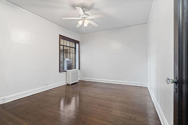 spare room featuring radiator, crown molding, dark wood-type flooring, and ceiling fan