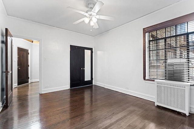 unfurnished bedroom featuring ceiling fan, radiator heating unit, dark hardwood / wood-style flooring, and ornamental molding