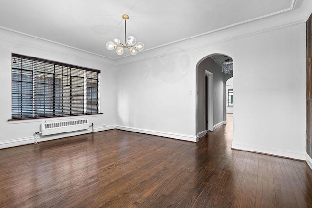 spare room with crown molding, radiator, a notable chandelier, and dark hardwood / wood-style floors