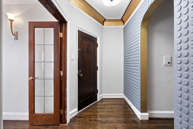 entrance foyer featuring crown molding and dark wood-type flooring