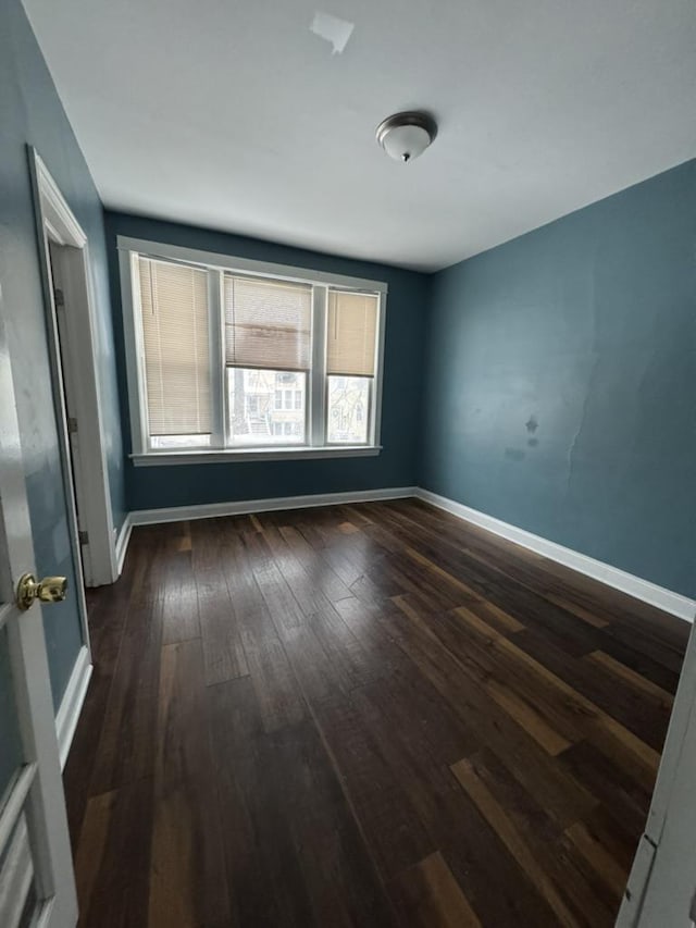 spare room featuring dark wood-type flooring