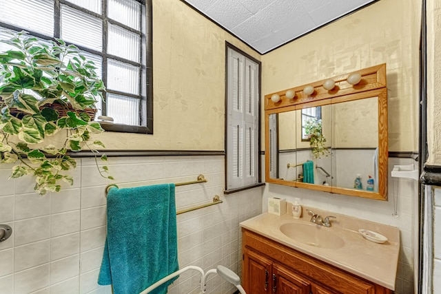 bathroom with a healthy amount of sunlight, a textured ceiling, and vanity