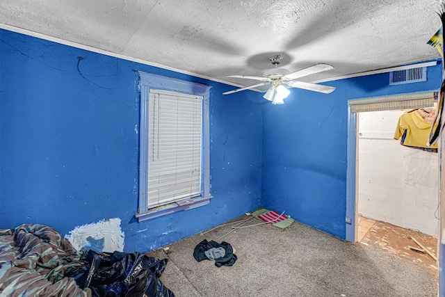 unfurnished bedroom featuring ceiling fan and a textured ceiling