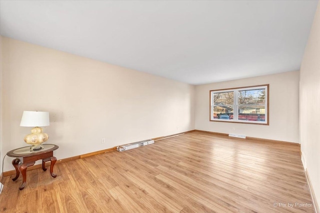 spare room featuring light hardwood / wood-style floors