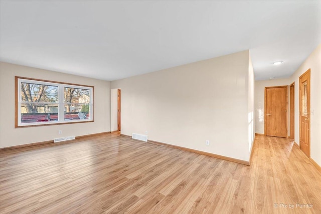 spare room with light hardwood / wood-style flooring