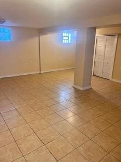 basement featuring light tile patterned floors