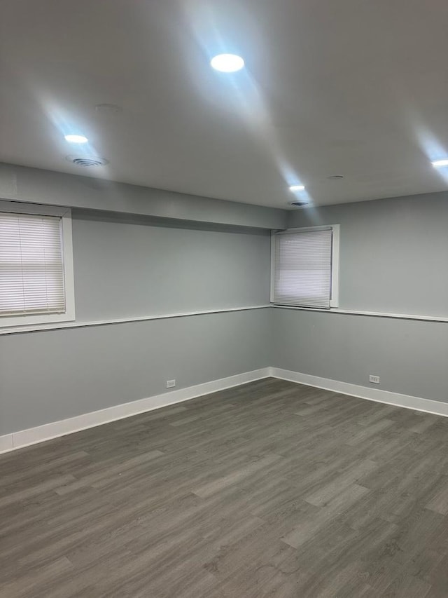 basement with dark hardwood / wood-style floors