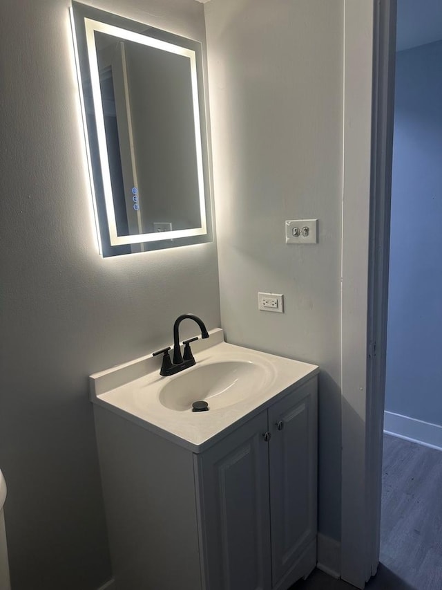 bathroom with wood-type flooring and vanity