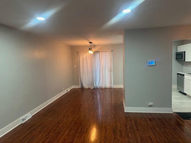 empty room with hardwood / wood-style flooring