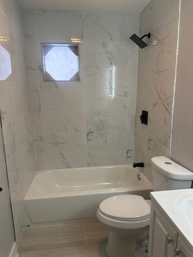 full bathroom with vanity, toilet, and tiled shower / bath