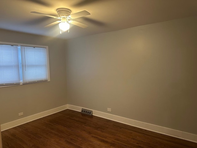 empty room with dark hardwood / wood-style floors and ceiling fan