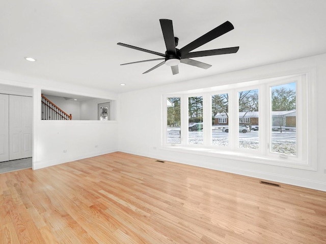 unfurnished living room with ceiling fan and light hardwood / wood-style floors