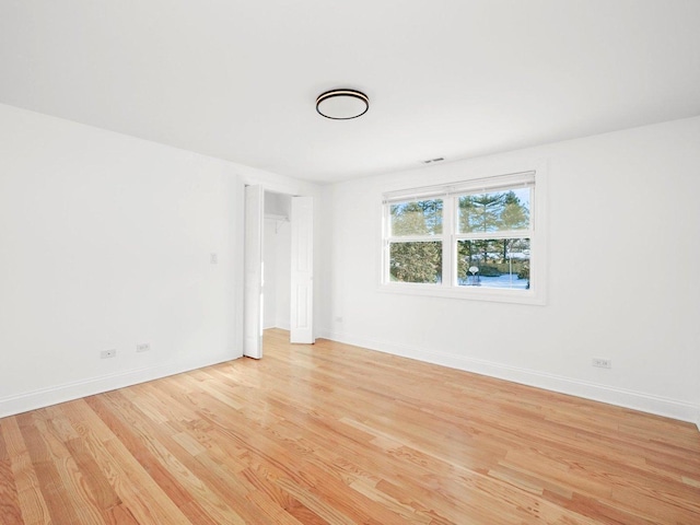 unfurnished room with light hardwood / wood-style floors