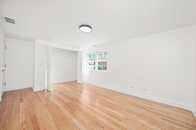 unfurnished bedroom with light hardwood / wood-style floors and a closet