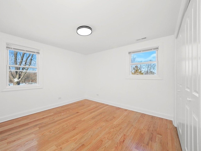 empty room with light hardwood / wood-style floors