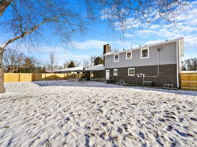 view of snow covered rear of property