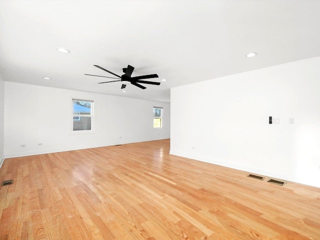 empty room with light hardwood / wood-style flooring and ceiling fan