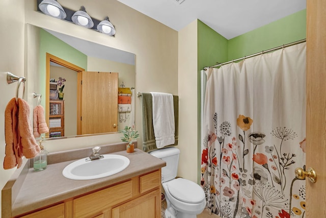 bathroom featuring vanity, curtained shower, and toilet