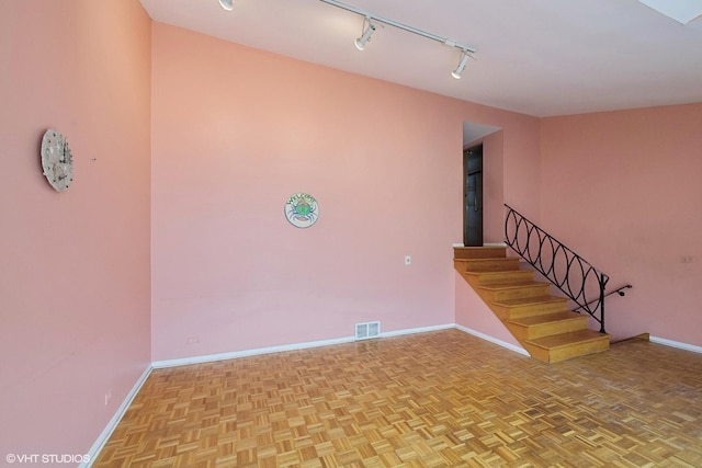 interior space featuring rail lighting and light parquet floors