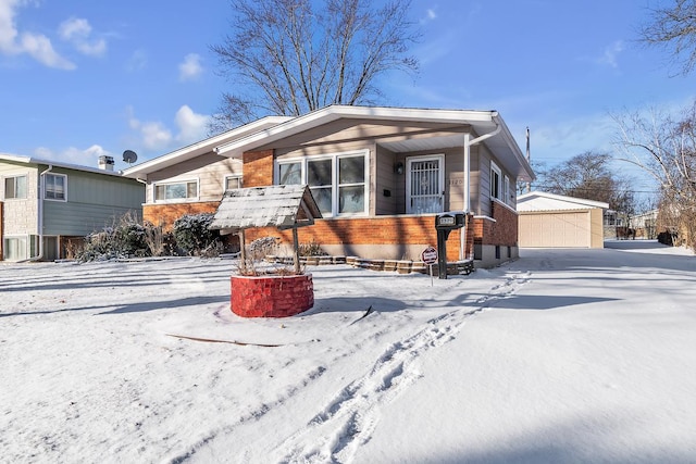 view of front of house featuring a garage and an outbuilding