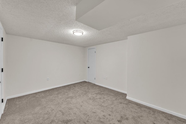 unfurnished room featuring carpet floors and a textured ceiling