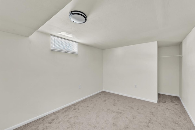 basement featuring light colored carpet