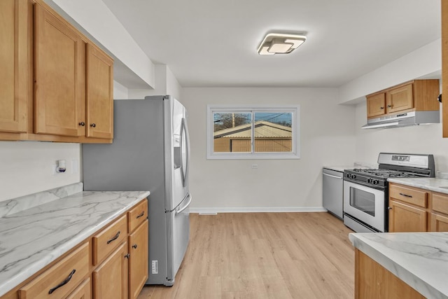 kitchen featuring appliances with stainless steel finishes, light stone counters, and light hardwood / wood-style floors