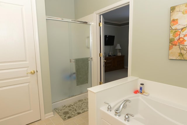 bathroom featuring tile patterned flooring, crown molding, and separate shower and tub