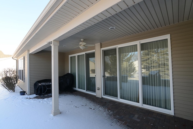 snow covered patio with ceiling fan