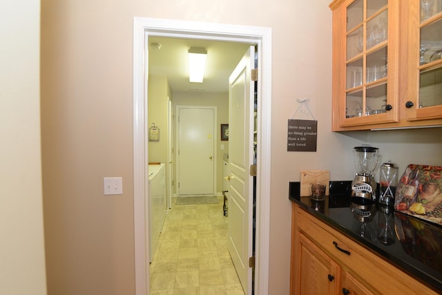 interior space with separate washer and dryer and dark stone counters