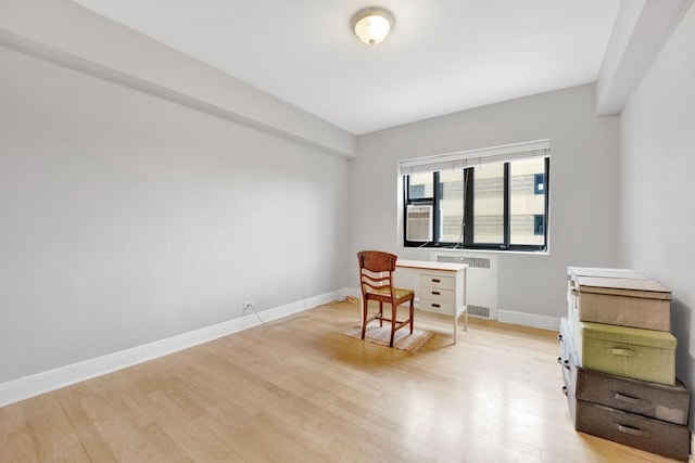 office space featuring light hardwood / wood-style flooring and radiator heating unit