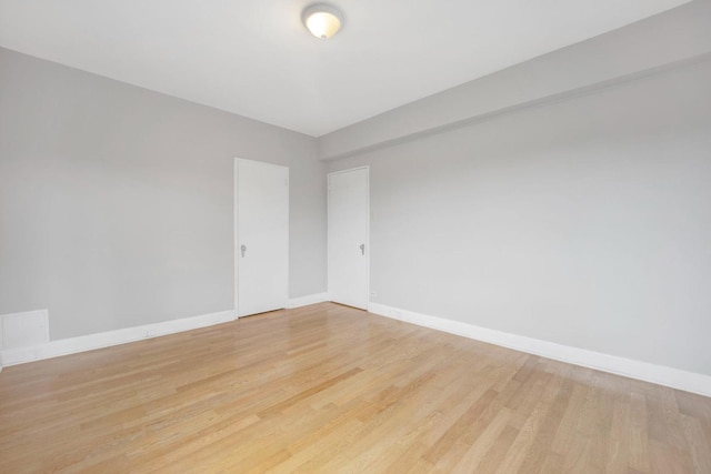 unfurnished room with light hardwood / wood-style flooring