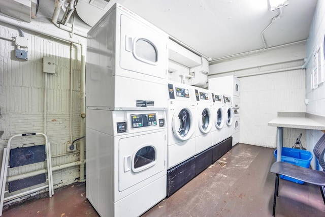 laundry area with heating unit, stacked washer / drying machine, and washing machine and dryer