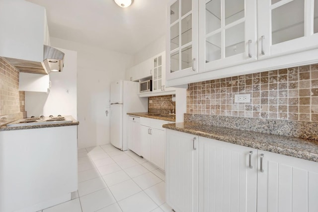 kitchen featuring sink, tasteful backsplash, stone countertops, white appliances, and white cabinets