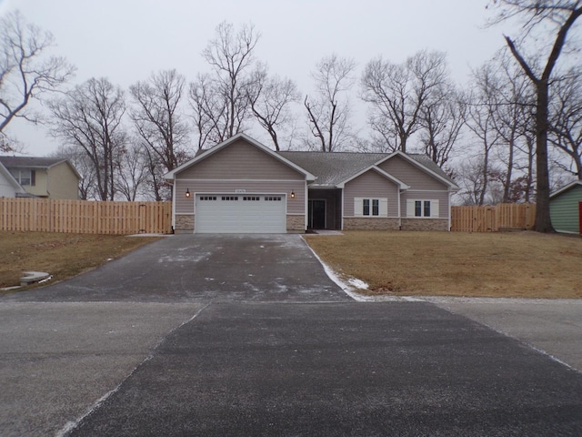 single story home with a garage and a front yard