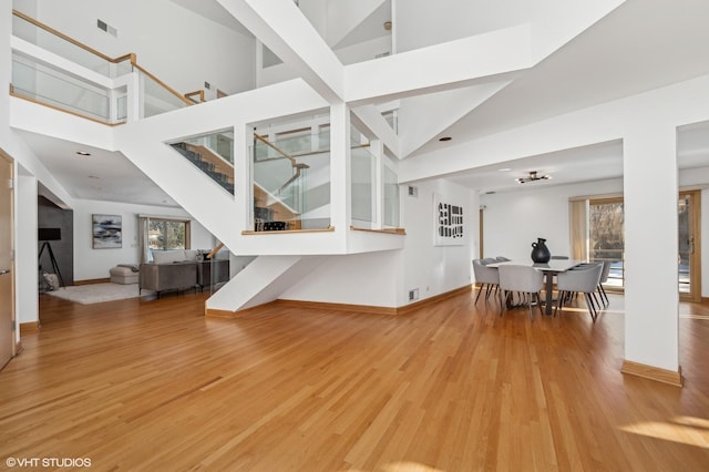 living room with a high ceiling and hardwood / wood-style flooring