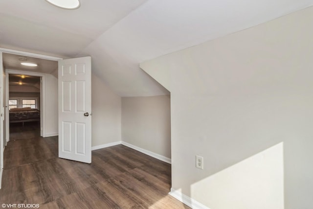 bonus room featuring vaulted ceiling and dark hardwood / wood-style floors