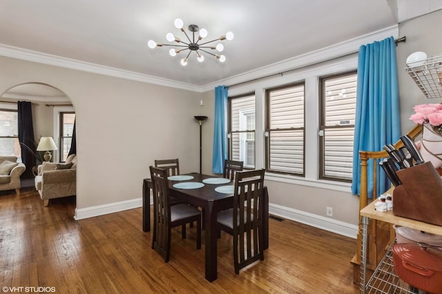 dining area with ornamental molding, dark hardwood / wood-style flooring, and a wealth of natural light