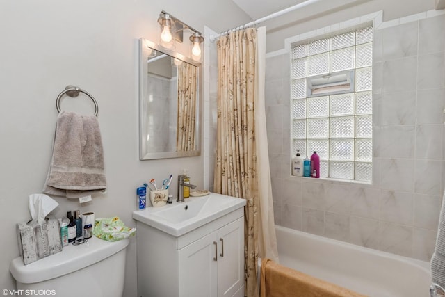 full bathroom featuring vanity, shower / bathtub combination with curtain, and toilet