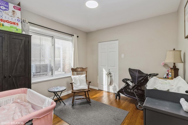 sitting room with wood-type flooring