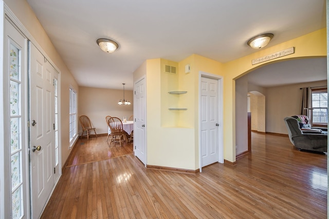 foyer entrance featuring hardwood / wood-style flooring and a chandelier