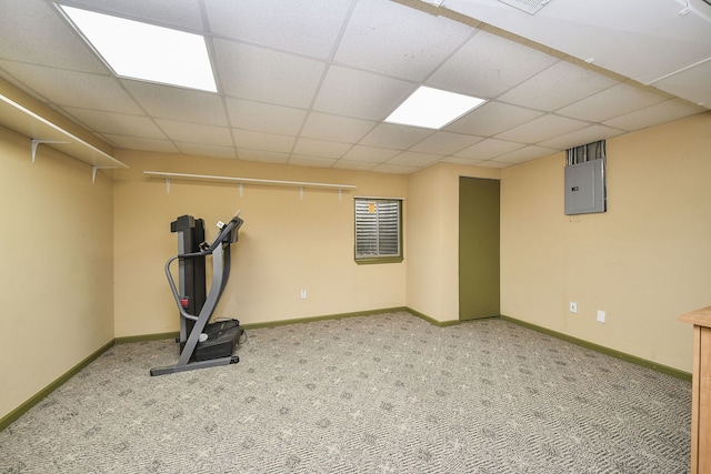 workout area featuring carpet, a drop ceiling, and electric panel