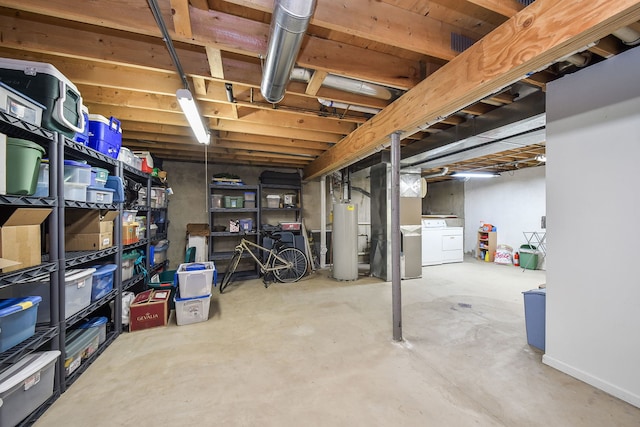 basement featuring washing machine and clothes dryer and water heater