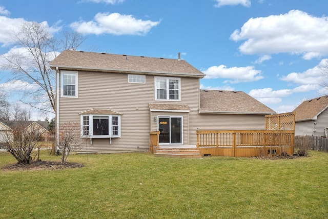 back of house featuring a yard and a deck