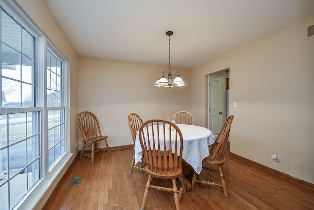 dining area with a notable chandelier and wood-type flooring