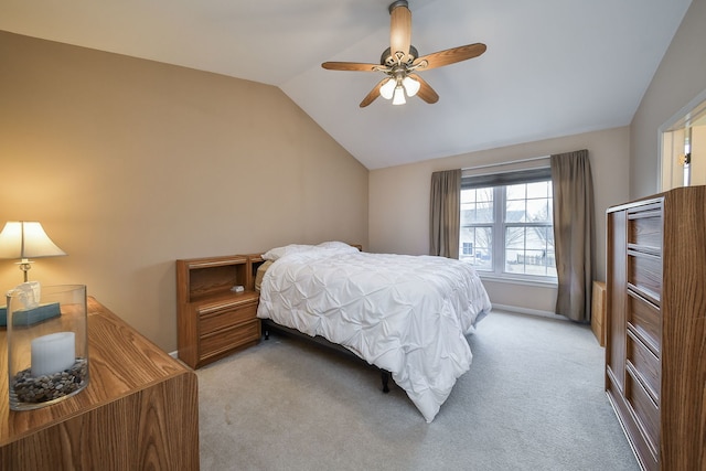 carpeted bedroom with ceiling fan and lofted ceiling