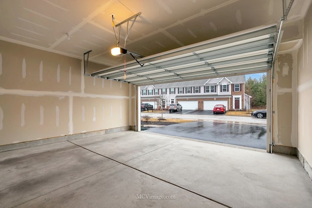 garage with a garage door opener and a carport