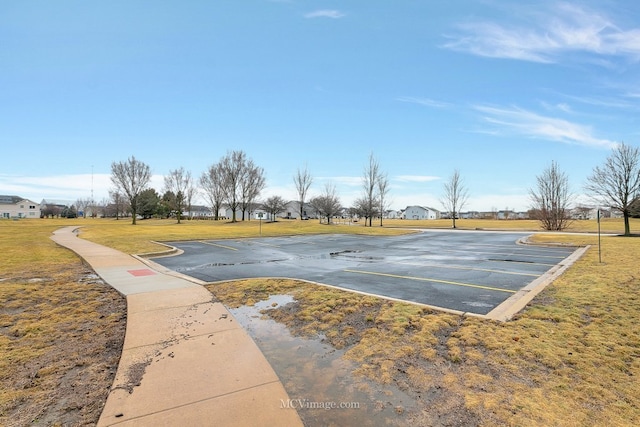 view of basketball court featuring a lawn